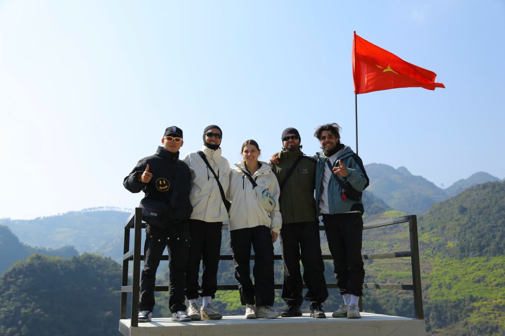 Ha Giang Loop Tour visitors wearing rain jackets during the rainy season.