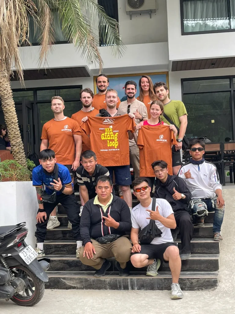 Foreigners taking picture with local driver in front of a hotel