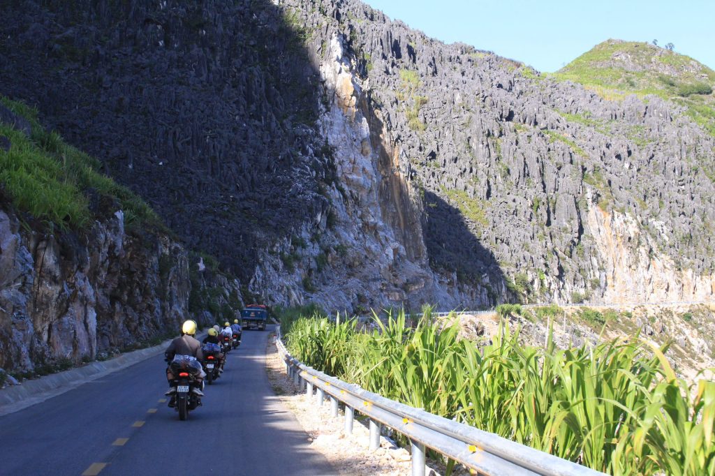 Visitors going across the Tham Ma Pass in Ha Giang Loop.